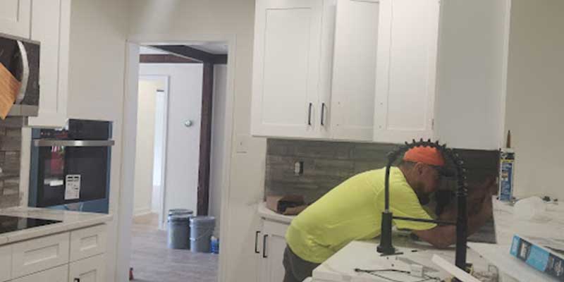 Demolition,Work,And,Rearrangement.,Worker,With,Sledgehammer,Destroying,Wall
